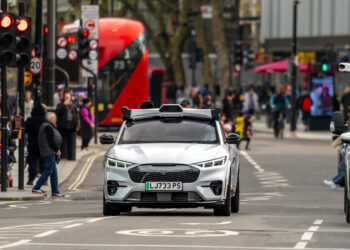 Wayve autonomous vehicle driving on a city street in london, symbolizing the $1 billion Series C funding secured under SoftBank's leadership.