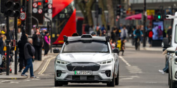 Wayve autonomous vehicle driving on a city street in london, symbolizing the $1 billion Series C funding secured under SoftBank's leadership.